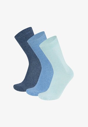 Three pairs of ribbed socks in dark blue, medium blue, and light blue shades. Made from soft fabric with a smooth texture and seamless design.