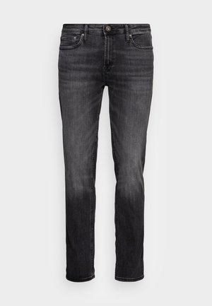 Jeans in denim nero con una vestibilità dritta, caratterizzati da un lavaggio sbiadito, cinque tasche e dettagli in metallo argentato. Orlo pulito e design classico.