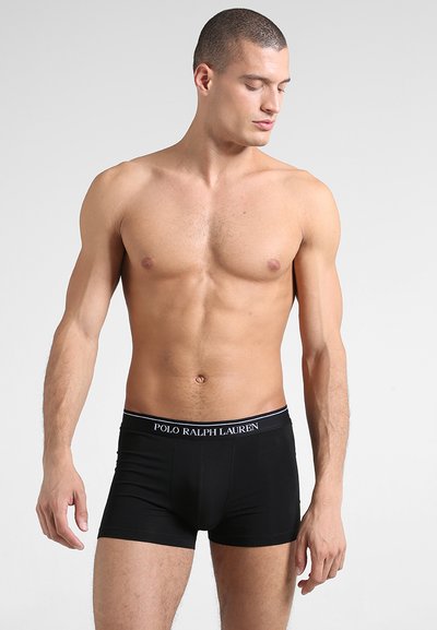 Boxers noirs en tissu lisse avec une ceinture élastique arborant le logo "POLO RALPH LAUREN". Conçus pour un look ajusté.