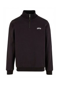 Musta huppari, jossa on neljännesvetoketju, ribatut hihansuut ja helma. Vasemmassa rinnassa on valkoisella brodeerattu teksti "UNFAIR". Pehmeä kangas.