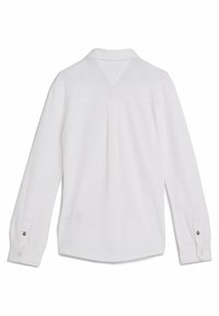 Camicia bianca a maniche lunghe con orlo curvo. Presenta una piega sul retro, colletto a punta e polsini abbottonati con dettaglio del logo sulla manica.