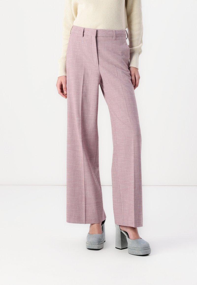 Light pink wide-leg trousers in a textured fabric with a subtle check pattern. Paired with gray platform heels.