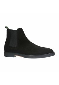 Stivale Chelsea in suede nero con una texture liscia, pannelli laterali elastici e un targhetta verde. Presenta una suola nera robusta con dettagli minimi.