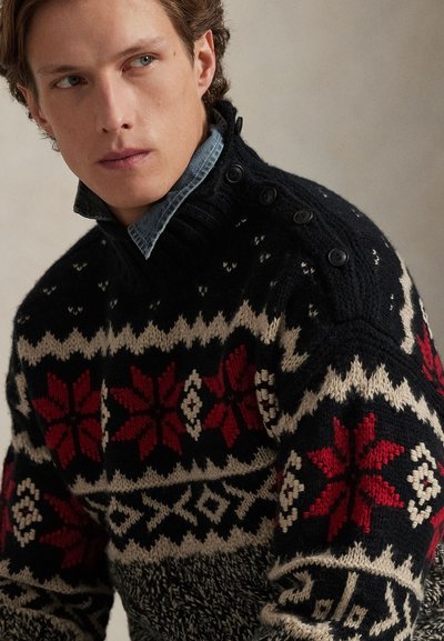 Knit sweater featuring a black base with red and white geometric patterns and snowflakes, high collar with button accents, textured fabric.