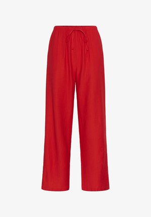Červené, ľahké nohavice s širokými nohavicami vyrobené z textúrovanej látky s elastickým pásom a šnúrkou na stiahnutie. Žiadne vrecká nie sú viditeľné.