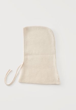 Beige ribbed knit balaclava with an attached string tie on a white background.