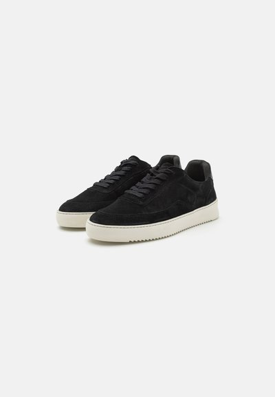 Black suede sneakers with flat laces, a textured upper, white rubber sole, and a minimalistic design. Features stitching and a cushioned collar.