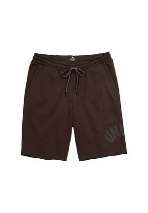 Brune elastiske shorts med snøre i taljen, sidelommer og et diskret print nær kanten på det ene ben.