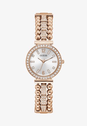 Montre en or rose avec un cadran rond, un fond argenté, des accents en cristal et un bracelet texturé à perles avec des maillons rectangulaires et des détails en cristal supplémentaires.