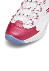 Biele športové topánky s červenými koženými akcentmi, zvršok z mäkkej sieťoviny a vzorovanými šnúrkami. Obsahuje poloprí-transparentnú modrú gumovú podrážku.