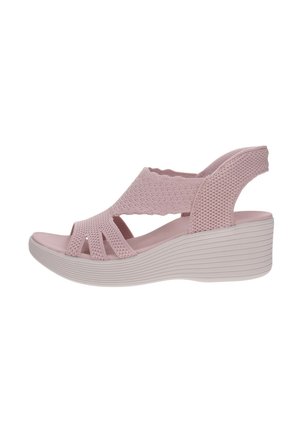 Sandalo con zeppa rosa con punta aperta e tomaia in tessuto lavorato a maglia, con cinturino posteriore e suola testurizzata.