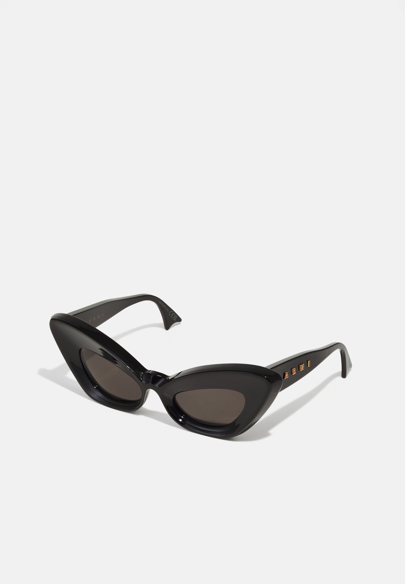 Black cat-eye sunglasses with glossy finish, dark tinted lenses, and branded arms featuring orange text. Smooth texture and sharp angular design.