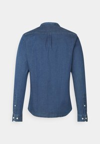 Long-sleeve blue denim shirt with buttoned cuffs shown from the back on a plain white background.
