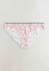 Bikini in cotone bianco con un motivo ripetuto di piccoli cuori rossi. Presenta un bordo nero con la scritta "NEXT" in bianco.