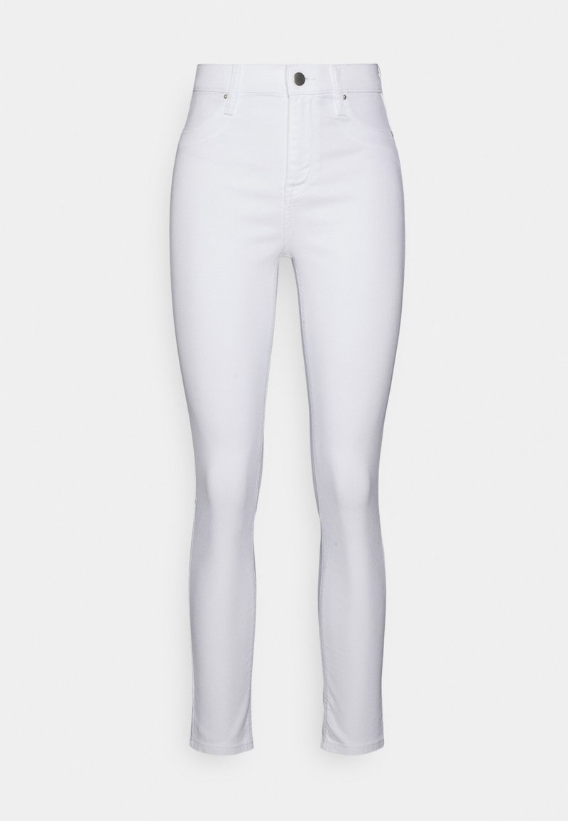 Jeans skinny brancos em denim com uma cintura alta, apresentando um design de bolso frontal, um botão metálico e uma textura suave.