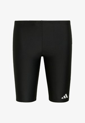Pantalones cortos de baño negros y ajustados hasta la rodilla con pequeño logotipo blanco de Adidas en la parte inferior de la pierna izquierda.