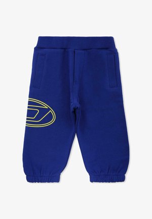 Pantaloni della tuta blu con cintura elastica, due tasche laterali e un grande logo giallo sulla gamba sinistra. Polsini elasticizzati alla caviglia.