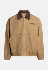Tan bomber jacket with a brown corduroy collar, elasticized hem, side pockets, and a chest pocket featuring a subtle zip closure.