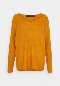 Senapsgul stickad tröja med långa ärmar, V-hals, ribbad textur och avslappnad passform. Etikett synlig vid halslinningen.