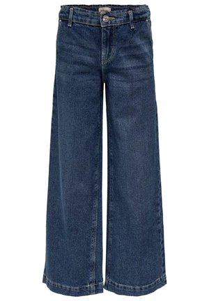 Mørkeblå vidde denim jeans med frontknap, lynlås, bæltestropper og synlige syninger på en hvid baggrund.