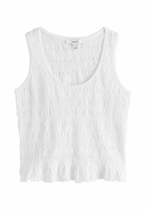 Valkoinen hihaton lyhyt paita, jossa kuvioitu rypytetty kangas ja röyhelöhelma, pyöreä pääntie sekä merkintä "NEXT" kauluksen sisäpuolella.