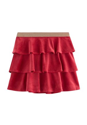 Punainen samettihame, jossa on kolme kerroksellista röyhelöä ja metallinvärinen kultainen joustovyö. Pehmeä tekstuuri, levenevä muotoilu eikä näkyviä kuvioita tai yksityiskohtia.