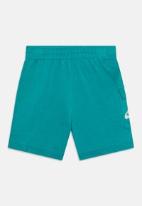 Turquoise shorts made of cotton blend, featuring an elastic waistband and side pocket with a white logo detail. Smooth texture and relaxed fit.