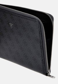 Black zippered wallet made of textured material, featuring a subtle logo pattern and a triangular metal logo accent.