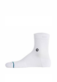 Calzini bianchi a girocollo con struttura a coste, logo nero sul lato e accentuazione turchese sulla punta. Materiale morbido, design alla caviglia.