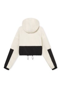 Cropped jacket with a fluffy white body, black lower panel, and hood; features elastic cuffs and drawstring hem for adjustable fit.