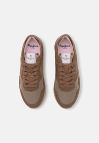 Sneaker marroni in materiale mesh e suede, con punta rotonda, design con lacci e un logo sulla linguetta e sul lato.