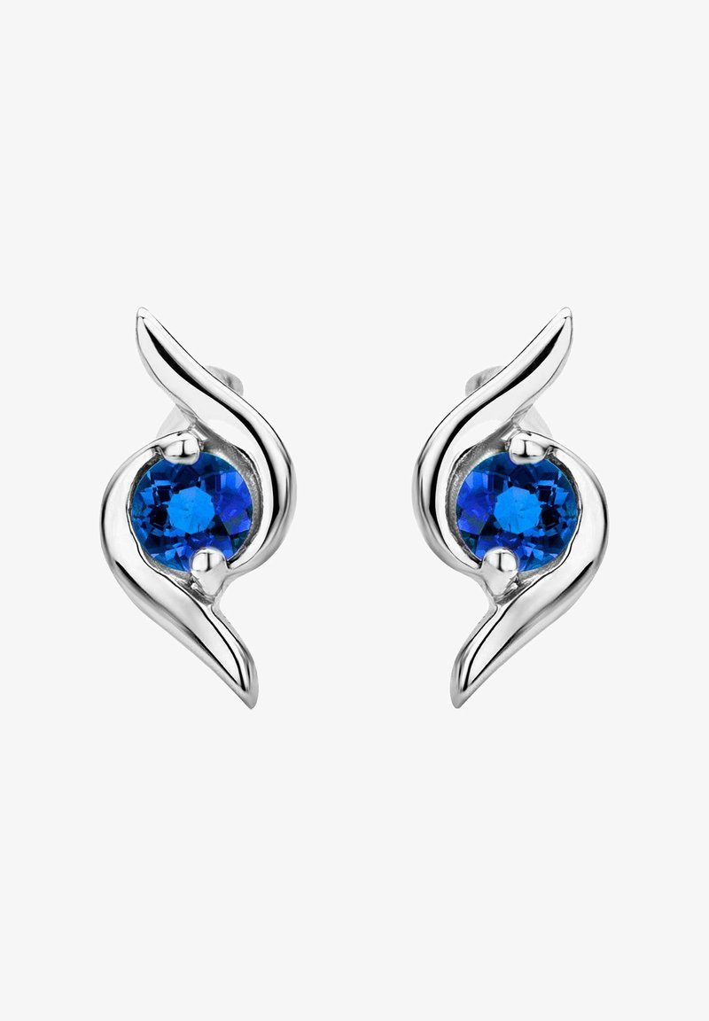 Silver earrings with a curvy design, featuring two round blue gemstones. The stones are set in a flowing silver setting.