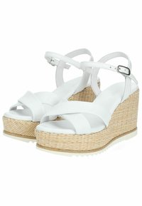 Sandali wedge bianchi con cinturini incrociati, suola in juta intrecciata e design testurizzato. Chiusura con fibbia e parte superiore liscia.