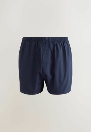 Temno modri bombažni bokserji s elastičnim pasom, enim sprednjim gumbom in gladko, lahko teksturo.