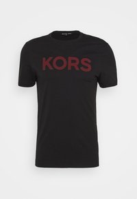 Černé bavlněné tričko s velkým, vínovým logem "KORS" na přední straně. Klasický kulatý výstřih a krátké rukávy s hladkou texturou.