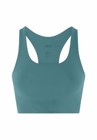 Rugalmas türkiz sportmelltartó versenyháttal, varrás nélküli elejjel és belső, nyomtatott címkével a Girlfriend Collective márkától, fehér háttéren bemutatva.