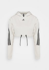 Sweat à capuche Adidas blanc court avec cordons noirs, trois bandes noires sur les manches, et logo Adidas sur la poitrine.