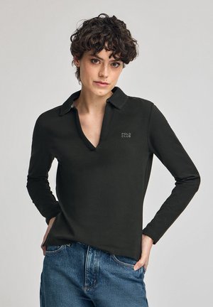 Black long-sleeve polo shirt with a v-neck, featuring a collar and "POLO CLUB" logo. Worn with blue jeans, fabric appears smooth and cotton-like.