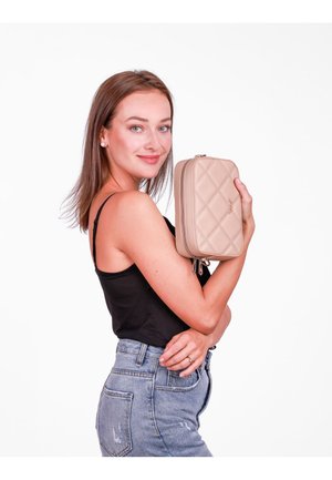 Beige quilted clutch bag with a diamond pattern, zip closure, and silver hardware, held against a white background.