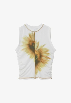 White sleeveless top featuring a central sunflower print, ruched sides, and gold trim along the neckline and hem. Soft, stretchy fabric.