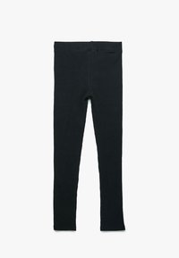 Svarta ribbade leggings med elastisk midja, som har en figurnära passform och mjuk textur, lämpliga för casual användning eller lager-på-lager.
