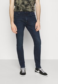 G-STAR REVEND SKINNY - Calças de ganga de corte skinny - worn in ultramarine