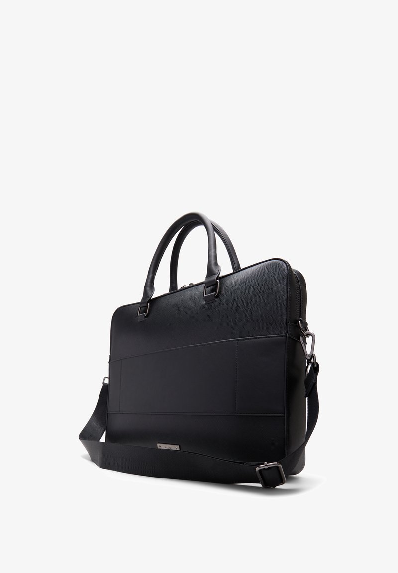 Sac de laptop en cuir noir avec des poignées doubles, une bandoulière détachable, une finition texturée et un design minimaliste avec des accents subtils.