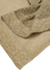 Beige geweven stof met een zachte textuur, met een iets lichtere rand. Het materiaal ziet er pluche en licht uit, met een subtiele glans.