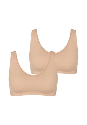 Twee naadloze draadloze beha's in huidkleur met brede bandjes en ronde halslijnen, afgebeeld tegen een witte achtergrond.