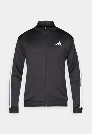 Černá sportovní bunda s vysokým límcem, předním zipem a bílými pruhy na bocích. Vyrobena z hladké, lehké látky, s malým logem na hrudi.