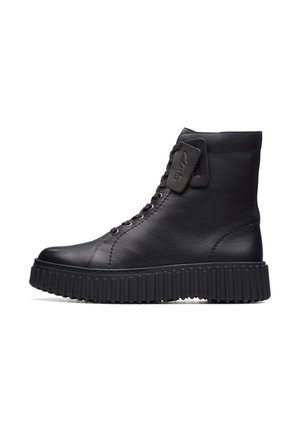 Black leather high-top boot with thick ribbed sole, laces, and stitched detailing, shown in profile on white background.