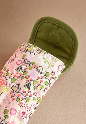 Quilted oven mitt in pastel pink with floral and geometric patterns, featuring a solid green padded cuff with a snap closure.