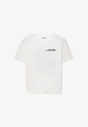 Maglietta bianca a maniche corte con testo nero sul petto a sinistra che recita: "La vita è piena di meraviglie. Prenditi il tempo per apprezzarla."