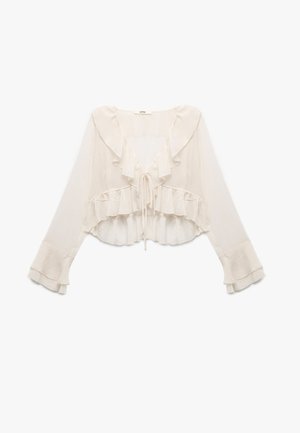 Lys beige, cropped bluse med lange ærmer, rynket halsudskæring og kant, samt snorelukning foran. Gennemsigtigt, letvægtsstof.